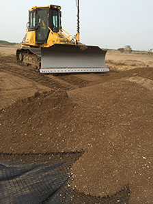 Automated doser blades gravel over geotextile cloth for road construction project&nbsp; Saskatoon Saskatchewan completed by Rite Choice Construction